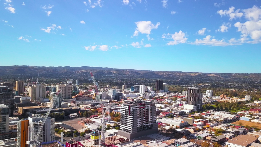 Aerial rising over the city of Adelaide, Australia and the hilly horizon
