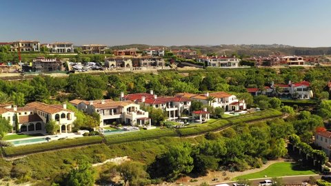 Aerial view over Newport Beach, Orange County California luxury real estate and neighborhood showing American wealth.