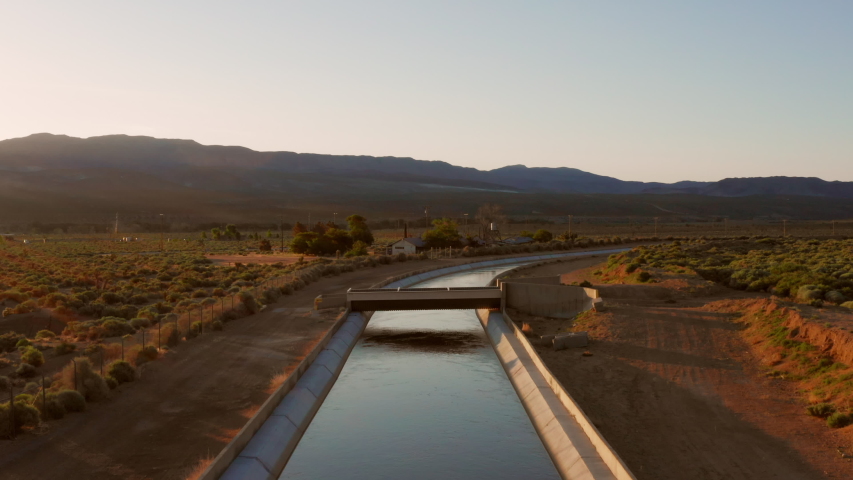 Sunrise at a waterway in the Sierra Nevada. Aerial shot.