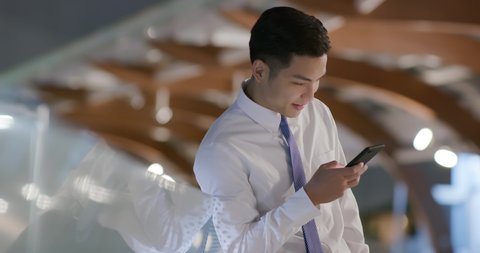 businessman use phone outdoor in the evening