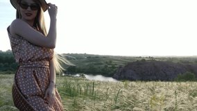 Beautiful girl in dress and hat on the field in the setting sun. - Powered by Shutterstock - Get 15% off with code: PIKWIZARD15