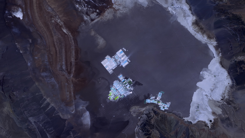 Evaporation ponds industrial site lithium production aerial satellite view sunrise animation. Contains public domain image by Nasa