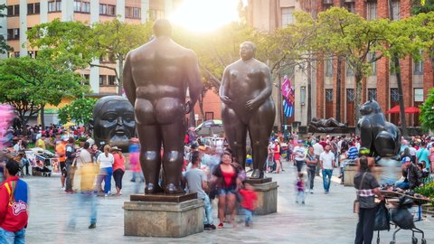 Medellin, Colombia - November 6: Time lapse view of Botero Square (Plaza Botero) showing people and outdoor sculptures by Colombian artist Fernando Botero at sunset in Downtown Medellin. Dolly right.