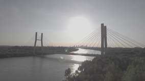 
Aerial view of Siekierkowski bridge. Flying over the river hung through a busy road. Warsaw downtown on the background at sunset. Filmed from 4K drone in RAW. Video for post-processing.