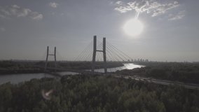 Aerial view. Warsaw is Poland. beautiful sunset overlooking the bridge and the river. Siekierkowski bridge. Flying over the river hung through a busy road. Filmed from 4K drone in RAW. Video.