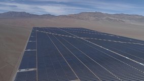 Aerial footage. Solar Energy Farm at Atacama Desert, Chile. Thousands modules rows passed on a reverse flight along the Solar Energy PV Plant an amazing scene from an aerial drone point of view 4/4