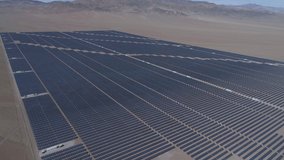 Aerial footage. Solar Energy Farm at Atacama Desert, Chile. Thousands modules rows passed on a reverse flight along the Solar Energy PV Plant an amazing scene from an aerial drone point of view 2/2