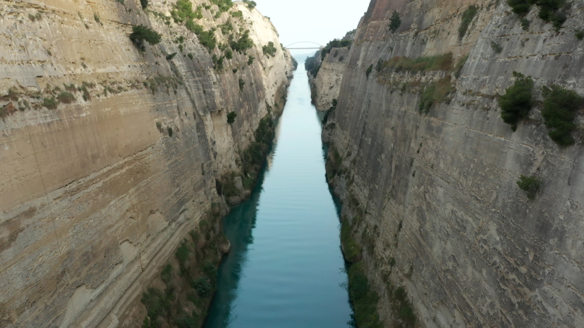 Corinth Canal with no people and text space, slow steady pull back through canyon