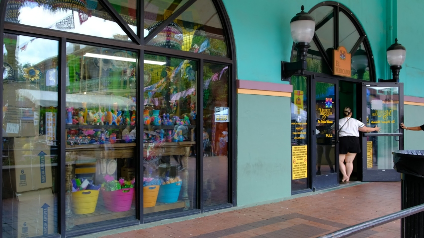 SAN ANTONIO, TEXAS - MAY 2, 201 9 - Entrance at El Mercado store with people walking in and out. It has displayed many Mexican souvenirs for sale and is situated in the Historic Market Square | Shutterstock HD Video #1030707860