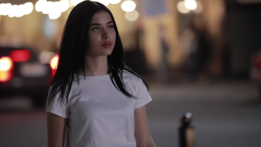 Woman walking in night city