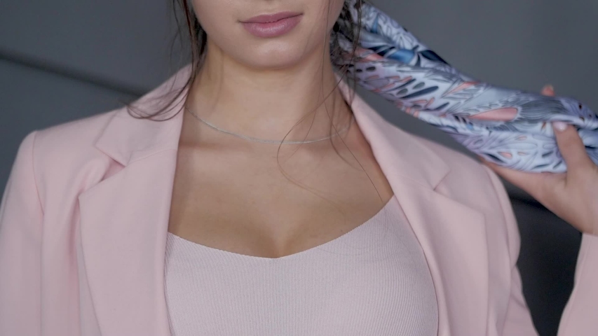 Pretty girl holding scarf. Fasion. Slowly