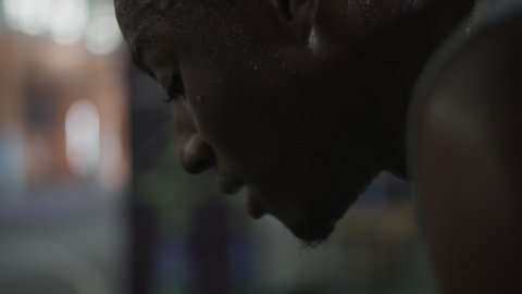 Close up on a face of an African basketball player taking a break after a basketball game