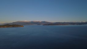 Panorama drone shot over Norwegian fjord. Mountain chain in background