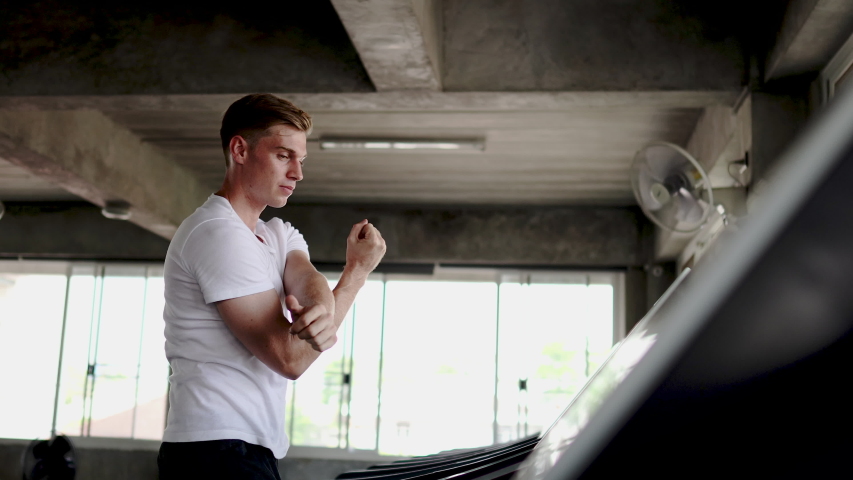 Strong men are walking exercising on treadmills, gym concepts and bodybuilding.