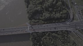 
Aerial view of a multi-level junction highway passing through a bridge on the outskirts of Warsaw. Filmed from 4K drone in RAW. Video for post-processing.