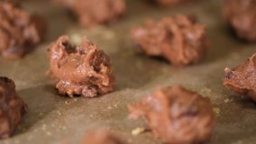 Close up footage of homemade chocolate cookies dough in a metal tray. Selective focus. Tracking shot.