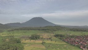 Aerial view of Rice fields and villages, near mount Agung. Bali, Indonesia. (Video in log format)
