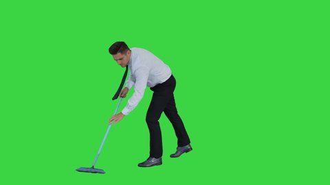 Man with thumb up holding broom in formal clothes or business outfit after sweeping floor on a Green Screen, Chroma Key.