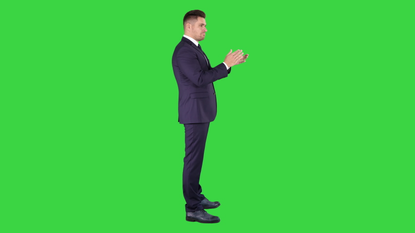 Business man clapping hands on a Green Screen, Chroma Key.