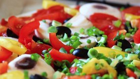 Tasty Pizza with many colorful ingredients. Delicious italian pizza mushrooms, tomatoes, cheese, onion, oil, pepper, salt, basil, olives. Food and snack close up macro. Full HD 1920x1080 Video Clip 