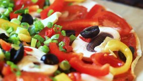 Tasty Pizza with many colorful ingredients. Delicious italian pizza mushrooms, tomatoes, cheese, onion, oil, pepper, salt, basil, olives. Food and snack close up macro. Full HD 1920x1080 Video Clip 