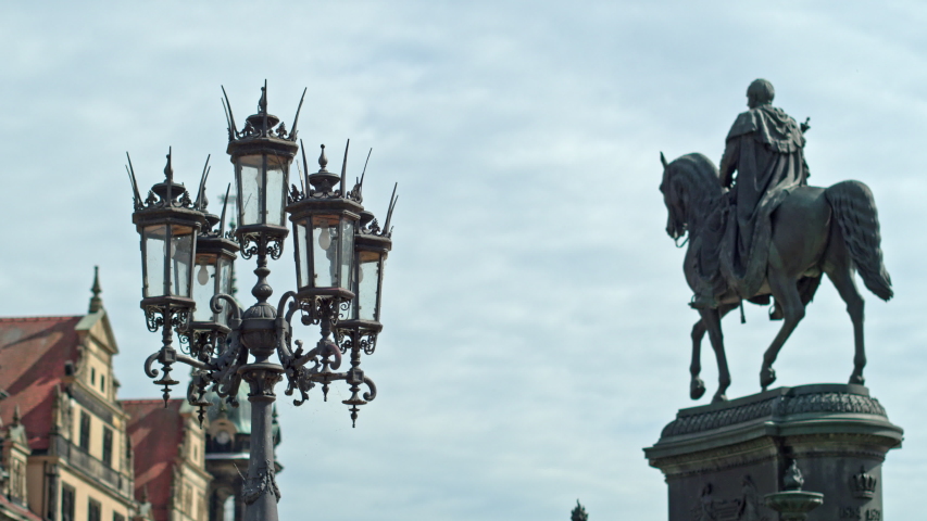 An ancient lantern and a statue of Johann Saxon on the theater square in Dresden.