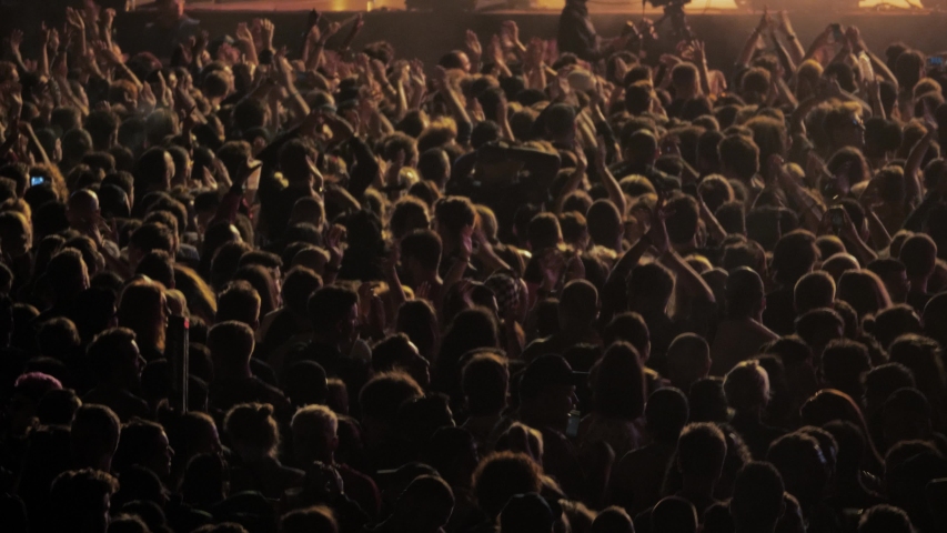 Big crowd of people dancing on music festival concert at night, street music big event applause raising hands Royalty-Free Stock Footage #1030762991