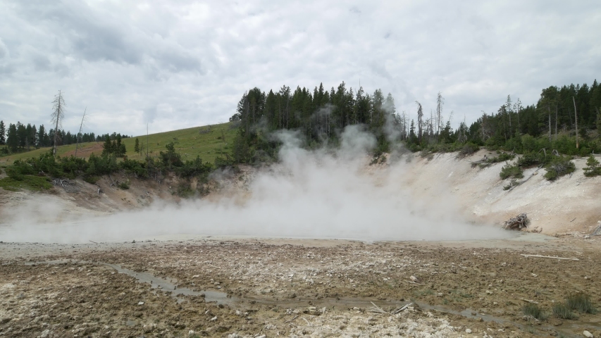 Breathtaking shot of steam slowly rising from the mud volcano area at Yellowstone National Park in Wyoming.