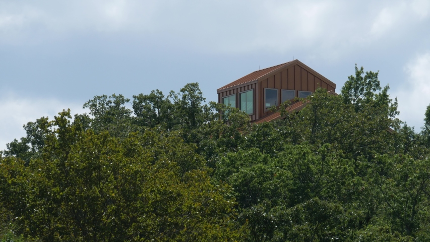 Wood cabin seen from the tops of trees at Lake Arbuckles, Oklahoma