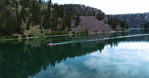 Drone circling boat on Wade and Cliff Lake in Montana during the summer.
