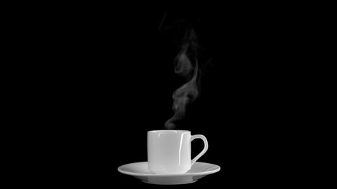Steam from a cup with boiling water. A trickle of steam rises from a cup of hot coffee. Absolutely black background, you can use to overlay an object. Steam over a cup of hot coffee.