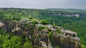 Aerial nature video. Flight in green forest mountain. Mountain old ruin cave town of Mangup.