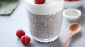 Chia pudding with yogurt and raspberries in glass. Healthy vegetarian food