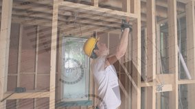 Digital composite of a male Caucasian carpenter hammering nails on a door frame with graphs and statistics running in the foreground - Powered by Shutterstock - Get 15% off with code: PIKWIZARD15