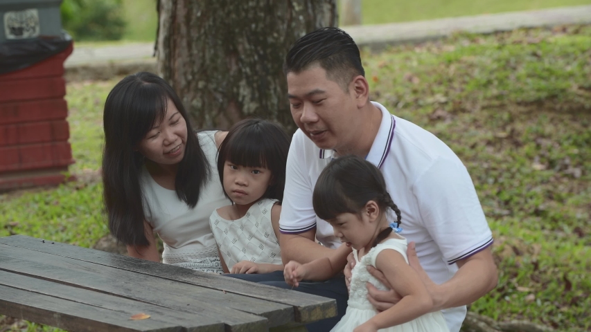 Happy Asian Family enjoying their time in the park 
 | Shutterstock HD Video #1030794017
