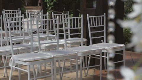White chairs in rows for the wedding ceremony.