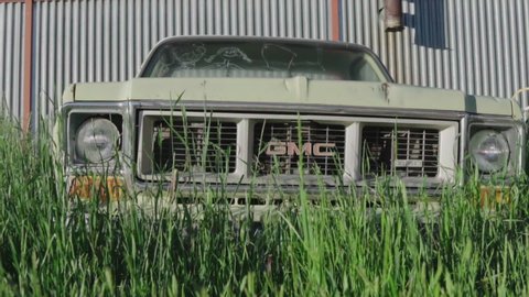 Dillon, Montana / United States - 07 03 2018: Abandoned GMC truck on a farm up against a barn