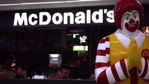 THAILAND - MAY 15, 2019: Mascot of McDonald's Fast Food Restaurant Chain Clown Statue of Ronald McDonald Making Thai Greeting Sawasdee at International Airport in Bangkok