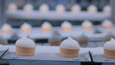Icecream automatic production line - conveyor belt with ice cream cones at modern food processing factory. Food dairy industry, manufacturing, engineering and automated technology equipment concept 스톡 비디오