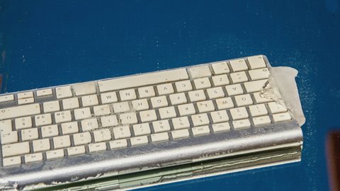 icy computer keyboard melting, time lapse view