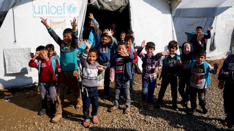 Erbil, Kurdistan / Iraq - 11 08 2018: Refugee camp Kurdistan Iraq November 2018 - school children wave to aid workers