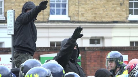 Dover, United Kingdom (UK) - 01 30 2016: Masked men give Nazi salutes