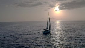 Forward to the Future. Flying drone view flight through across sail yacht to dawn. Yacht Sailing Aerial 4k video. sunny atlantic ocean water.Canary paradise island with aqua blue Sky Sea Water