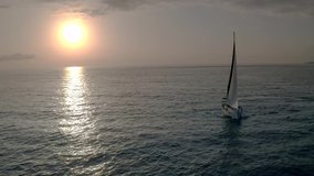 Flying drone view flight through across sail yacht to the sun. Yacht Sailing Aerial 4k video. sunny atlantic ocean water.Canary paradise island with aqua blue Sky Sea Water
