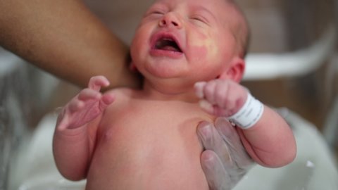 Newborn baby taking a bath for first time at the hospital