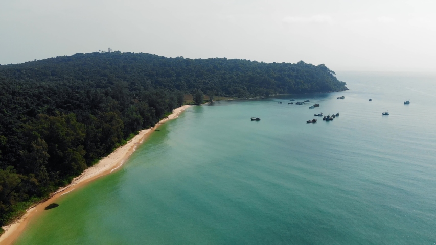 Long deserted beach with white sand and clear water. Aerial top view from above. island Koh Rong Samloem, Sihanoukville, Cambodia. White sand beach and calm sea. flying, movement motion, 4K move drone
