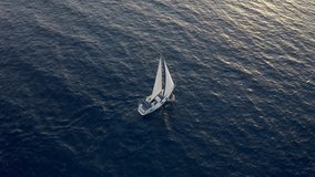 Yacht sailing on opened sea. Flight Around Sail and Ship. Sailing boat. Yachting Aerial 4k video. Yacht from above. Sailboat from drone. Sailing video. Yachting at windy day.