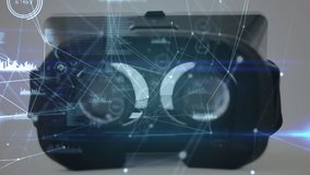 Digital composite of a virtual reality headset on a table with lines and graphs in the foreground - Powered by Shutterstock - Get 15% off with code: PIKWIZARD15