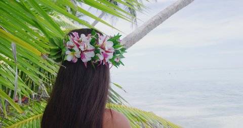 Hawaii beach woman luau dancer relaxing wearing wreath of fresh flowers on Tahiti Bora Bora, French Polynesia. Shot on RED cinema camera in SLOW MOTION.