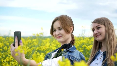 Girls in a yellow box do a photo, The girls are bright yellow field